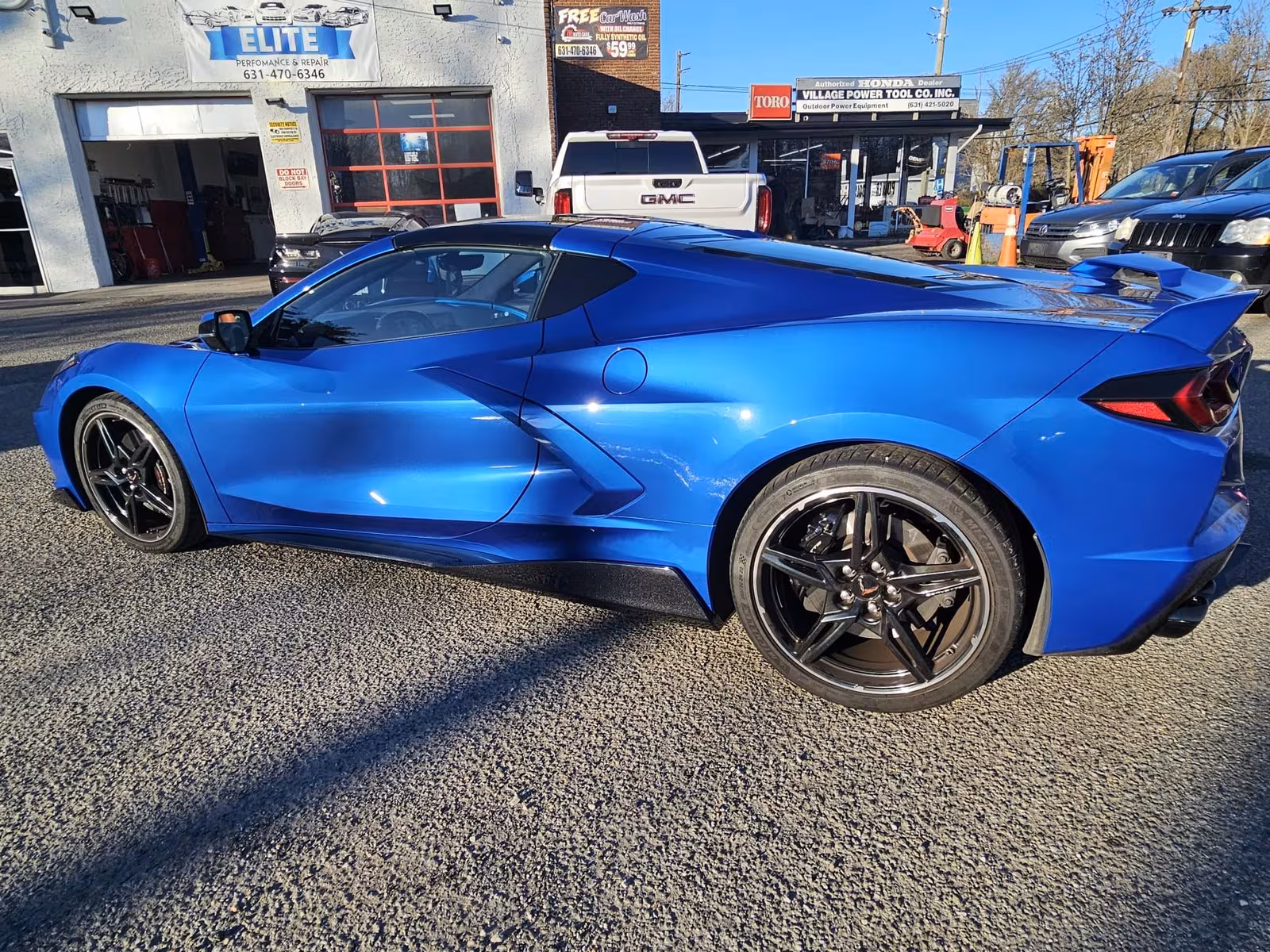 Corvette rear three-quarter view outside Elite Performance & Repair