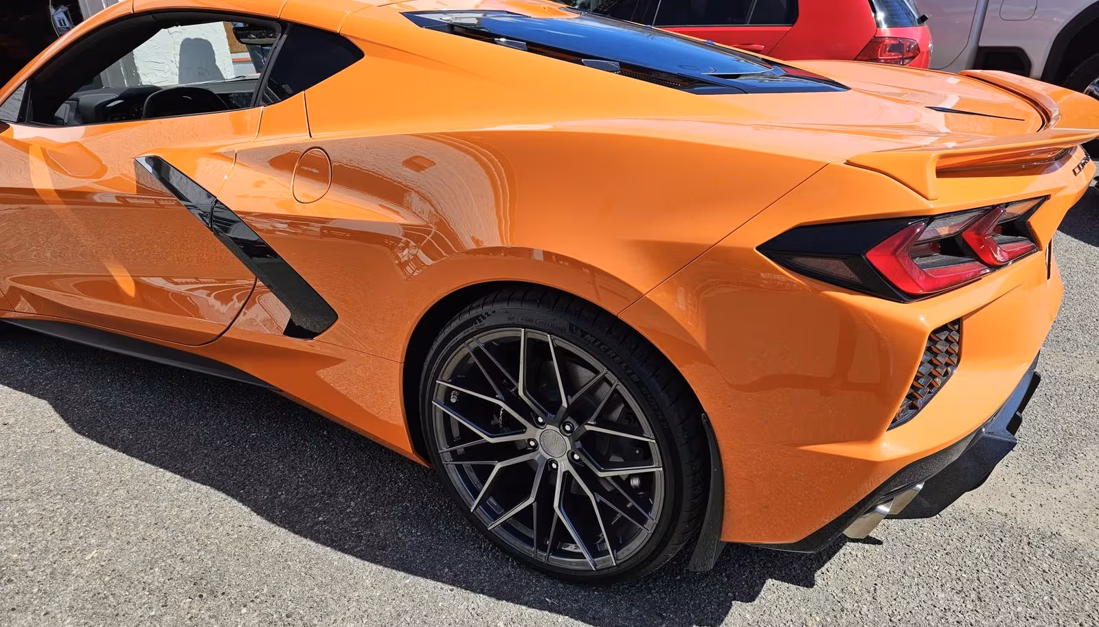 Orange Corvette outside the shop, second angle
