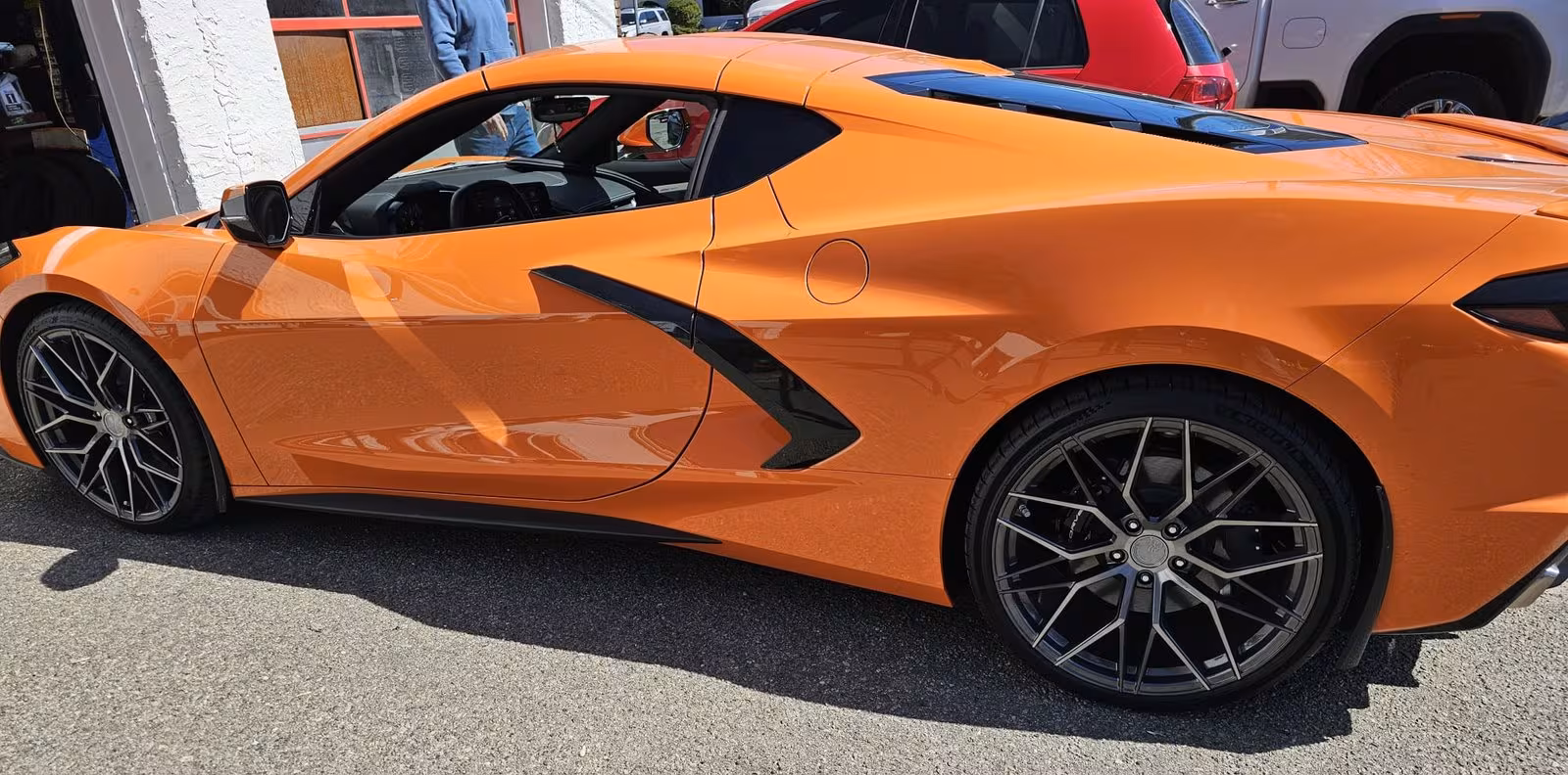 Orange Corvette outside the shop
